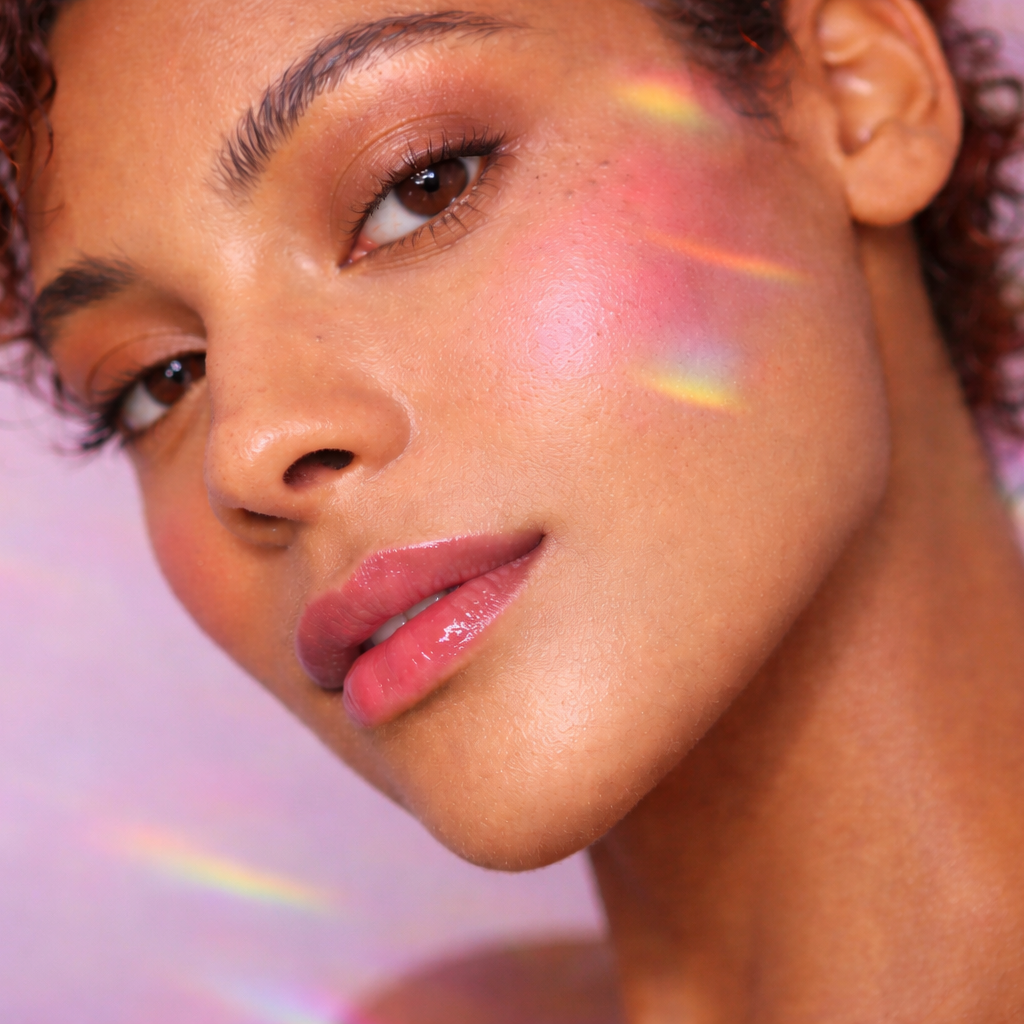 Close-up of a model wearing softly sculpted bronzer with warm, sun-kissed skin and natural glow across the cheeks and eyes