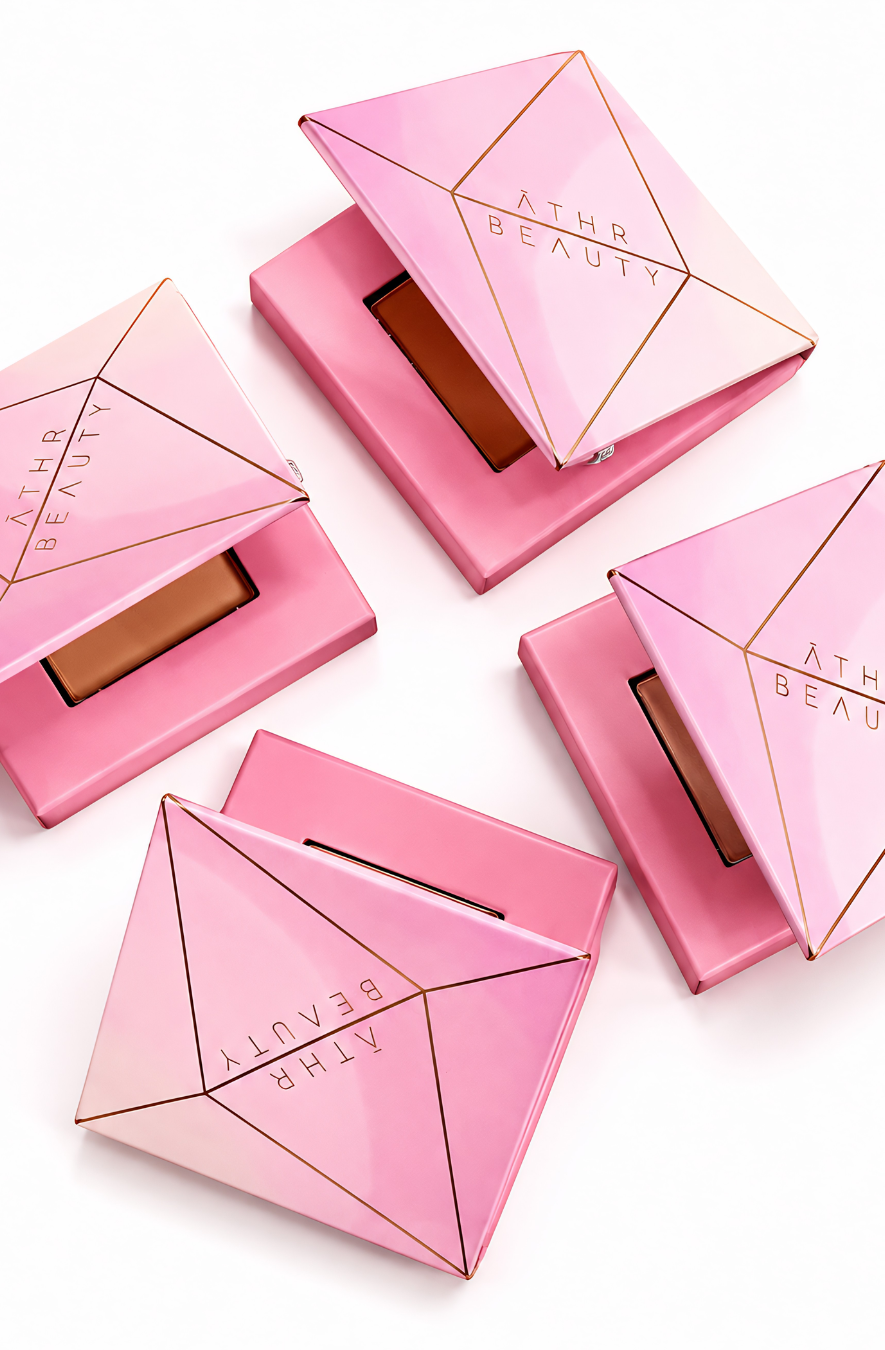 Pink compact powder cases with 'Athr Beauty' branding on a white background