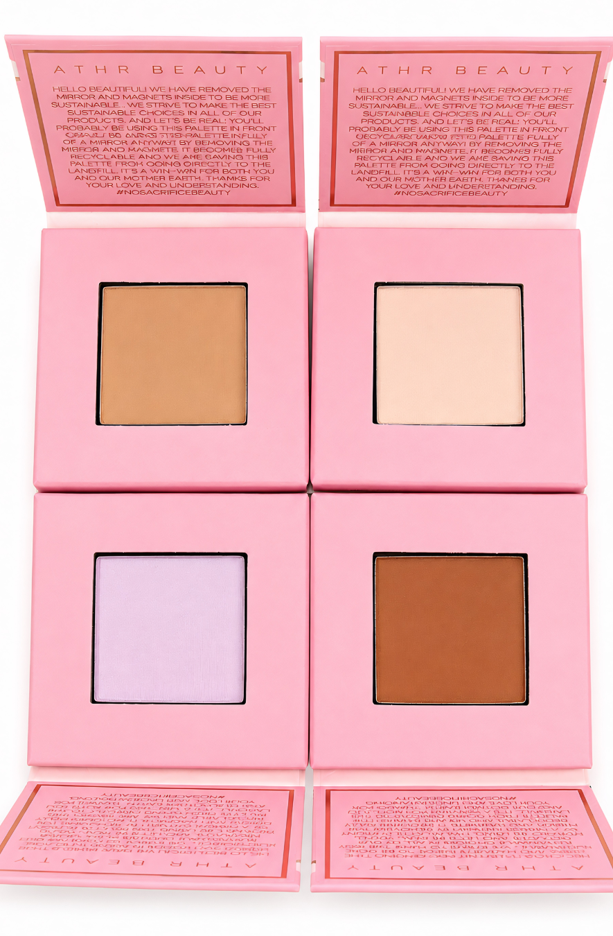 Four open pink compact cases of ATHR Beauty’s Desert Mirage Blurring Powder arranged in a square on a white background. Top-left shows 'Citrine Sand' (a soft, warm beige with a banana-yellow tint), top-right shows 'Rose Mesa' (a soft, creamy beige with a subtle pink tint), bottom-left shows 'Sagebrush' (a pale lavender-tinted powder), and bottom-right shows 'Sienna Dune' (a deep terracotta-brown shade).