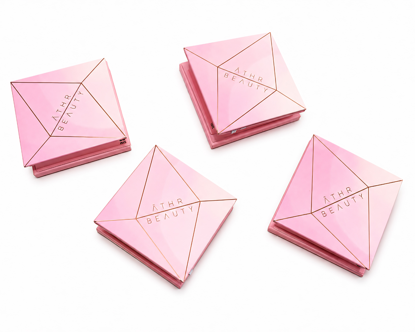 Four pink cosmetic cases with 'Athr Beauty' branding on a white background