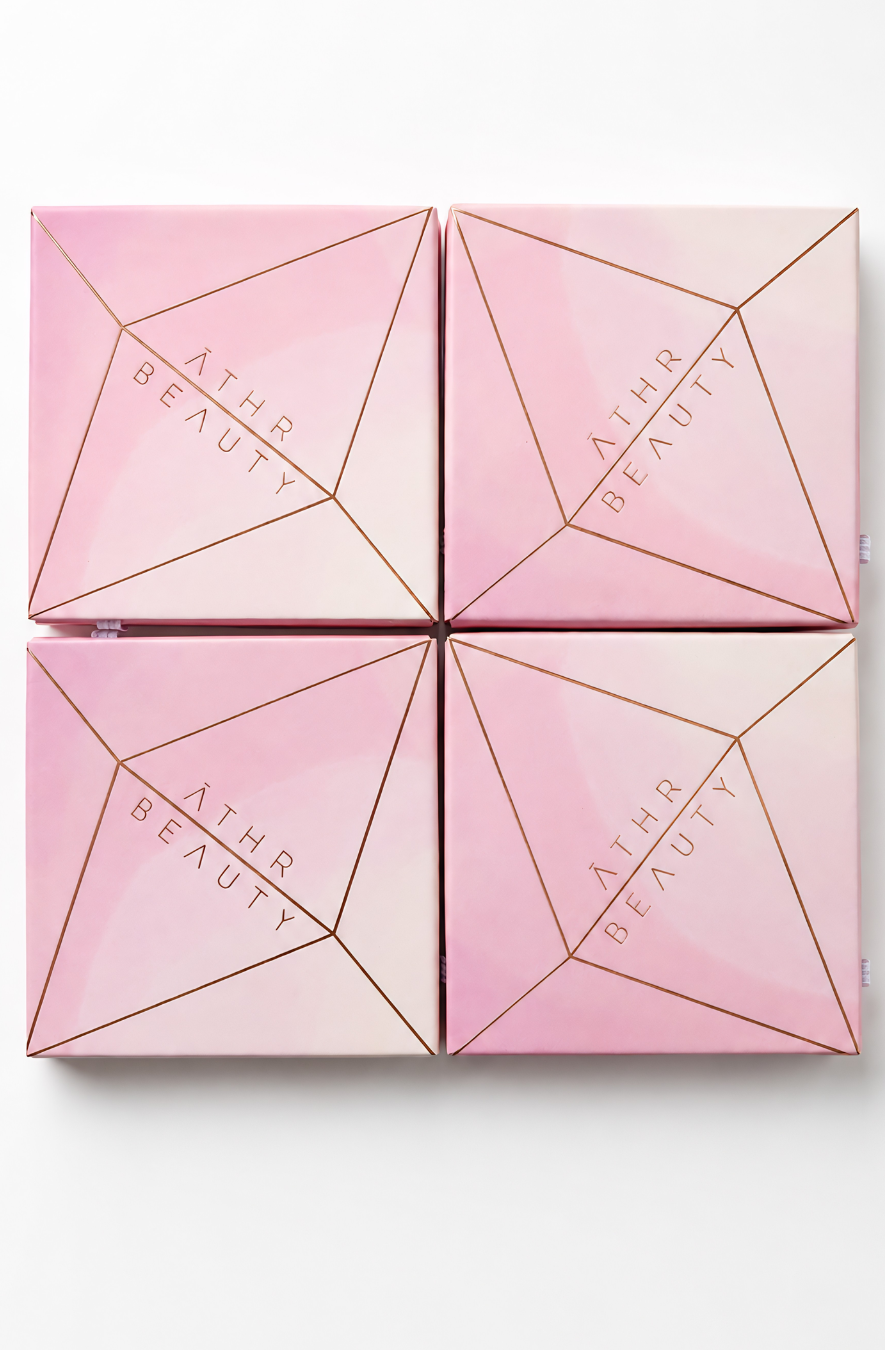 Pink cosmetic box with geometric design and 'Athr Beauty' branding on a white background
