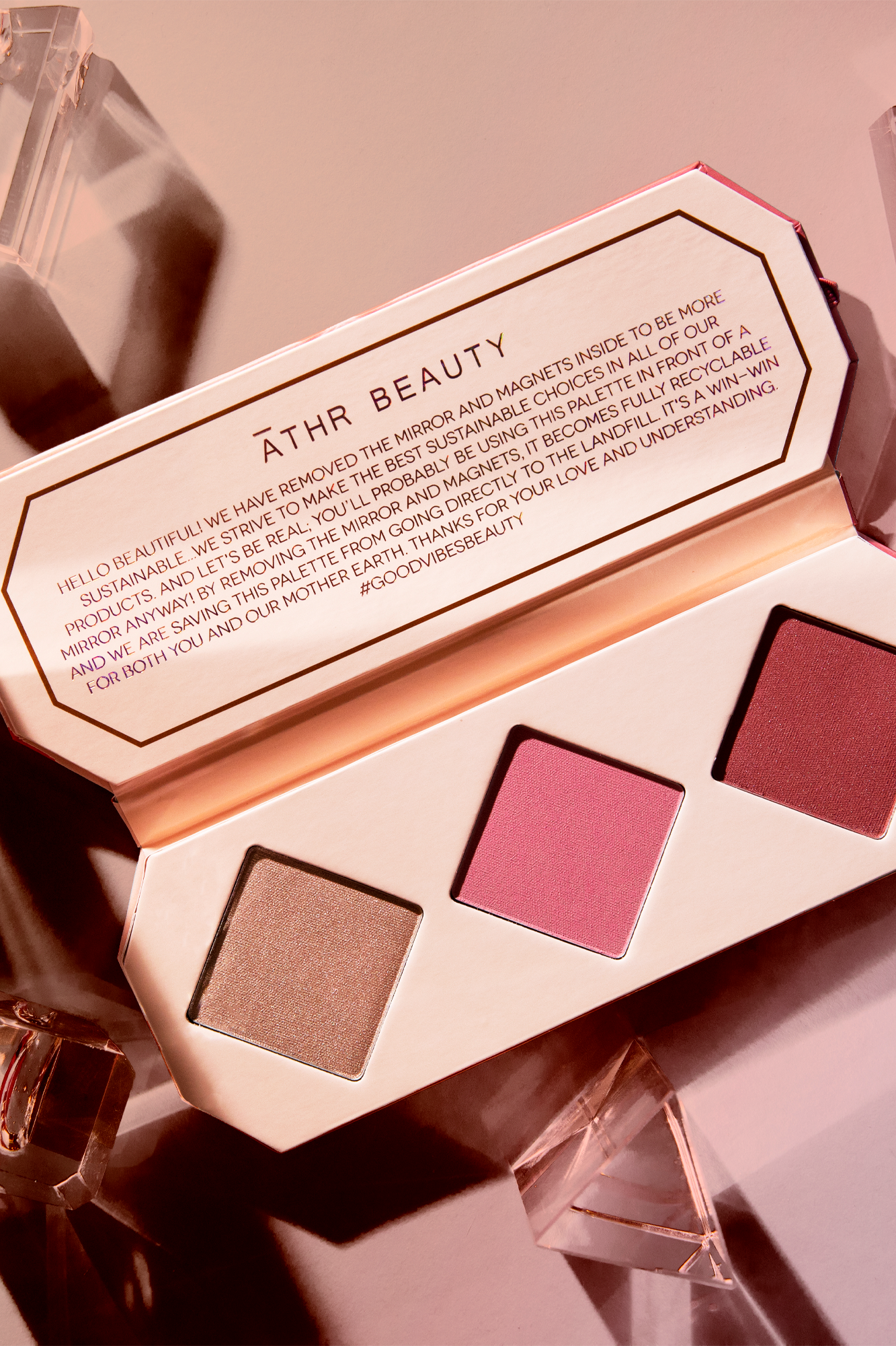 Editorial product image of the 3-Pan "Ruby" Crystal Charged Cheek Palette, sitting open to show the shade color.