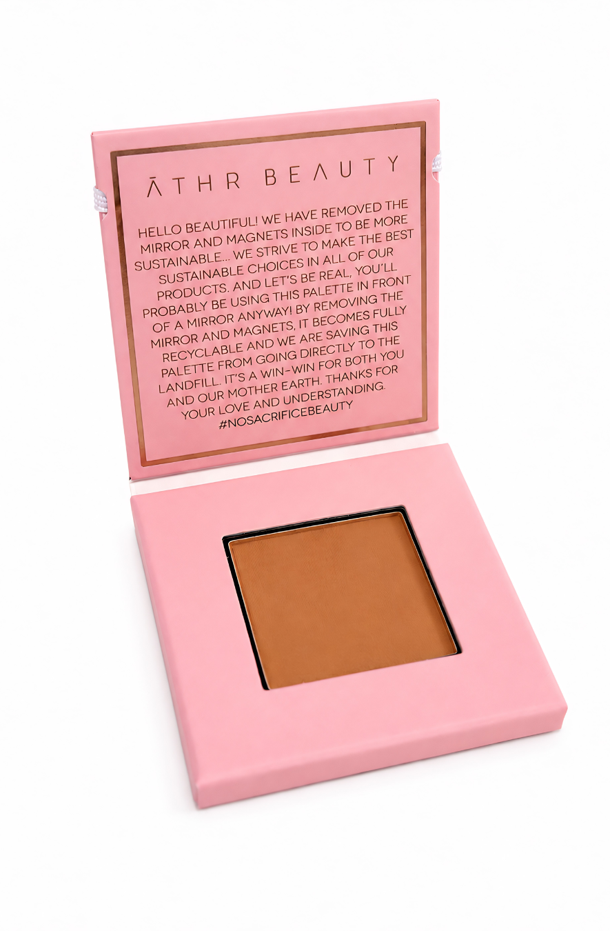 Pink makeup palette of Athr Beauty's 'Desert Mirage Blurring Powder' in the shade 'Sienna Duna' (a soft, rich honey-terracotta) on a white background