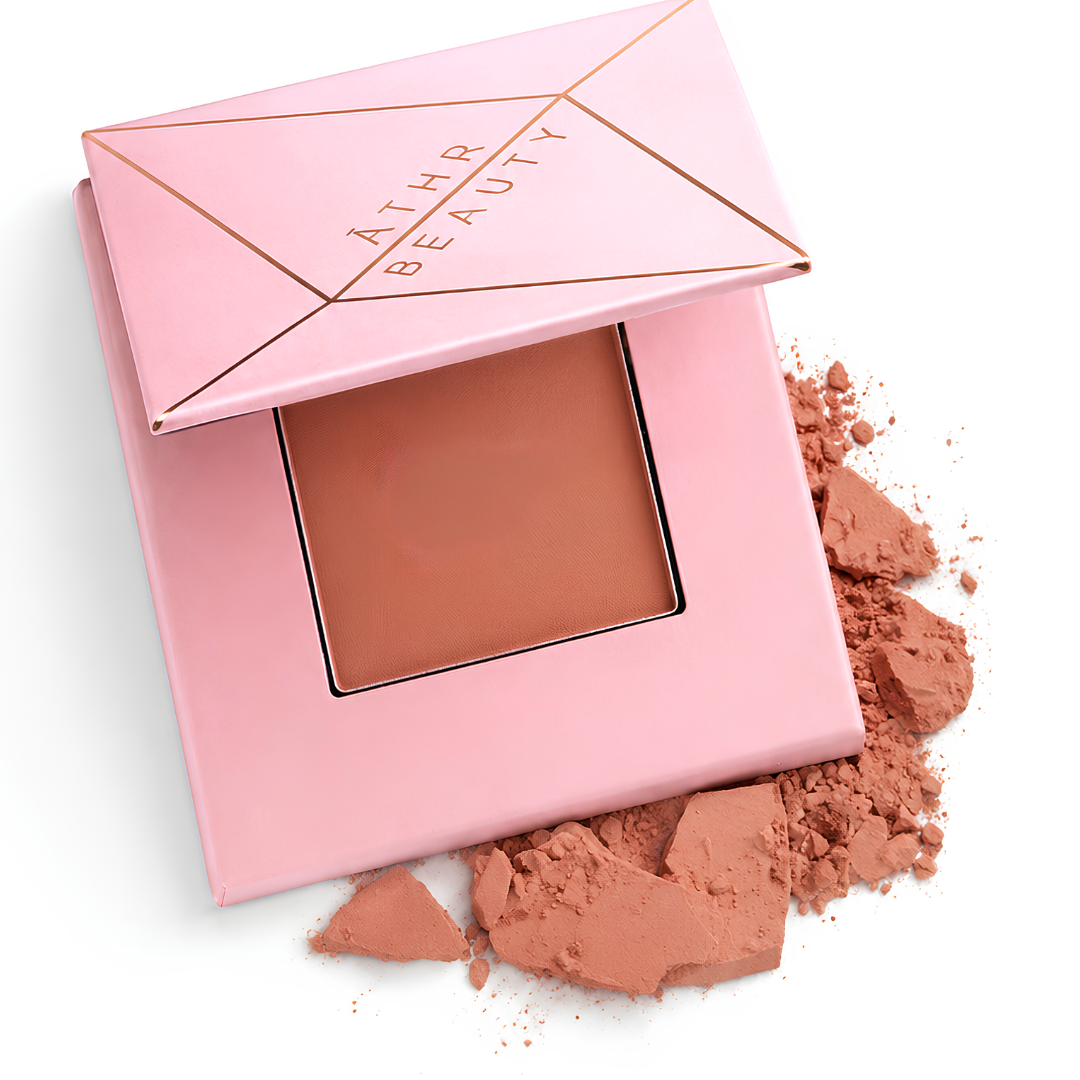 Pink compact powder with powder color and 'Athr Beauty' branding on a white background
