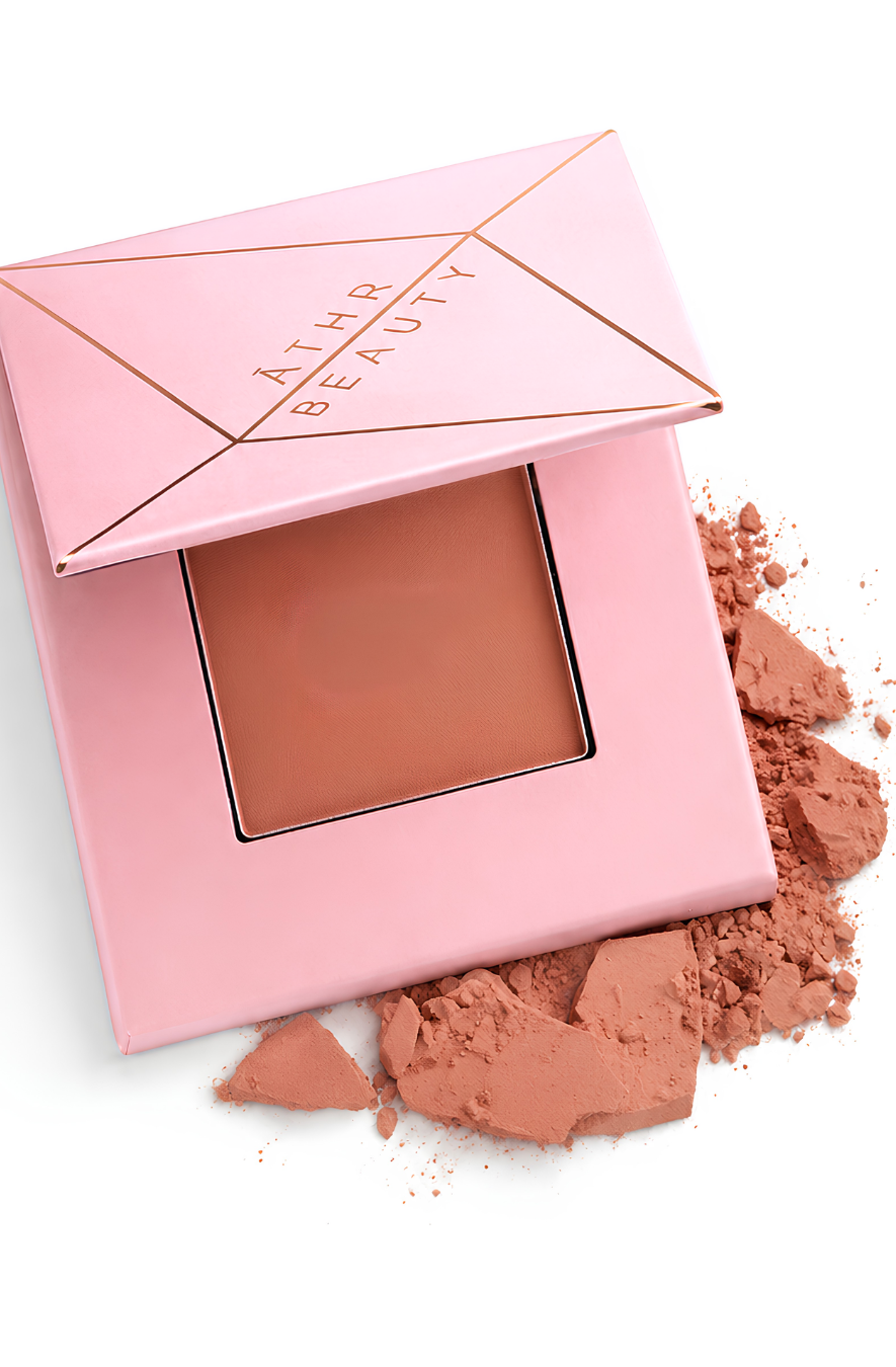 Pink compact powder with powder color and 'Athr Beauty' branding on a white background