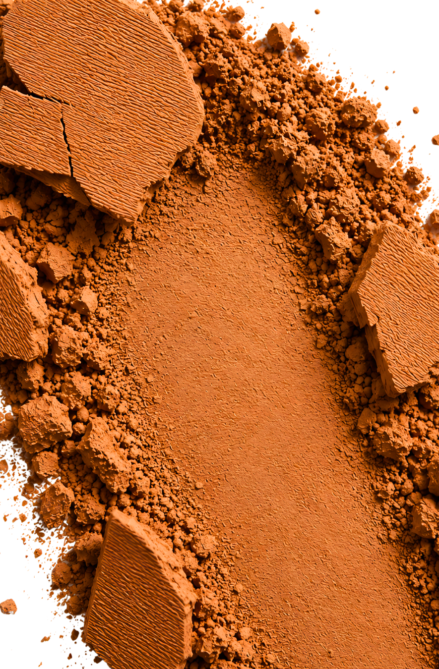 Close-up of brown makeup powder with a pressed powder compact on a white background