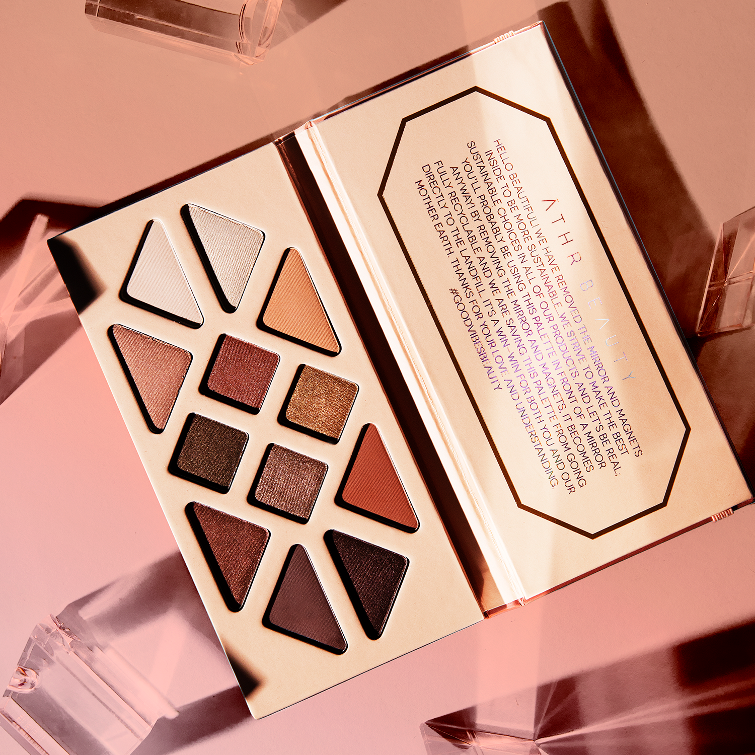 Editorial product image of the 12-Pan "Summer Solstice" Crystal Eyeshadow Palette, sitting open to show the shade color.