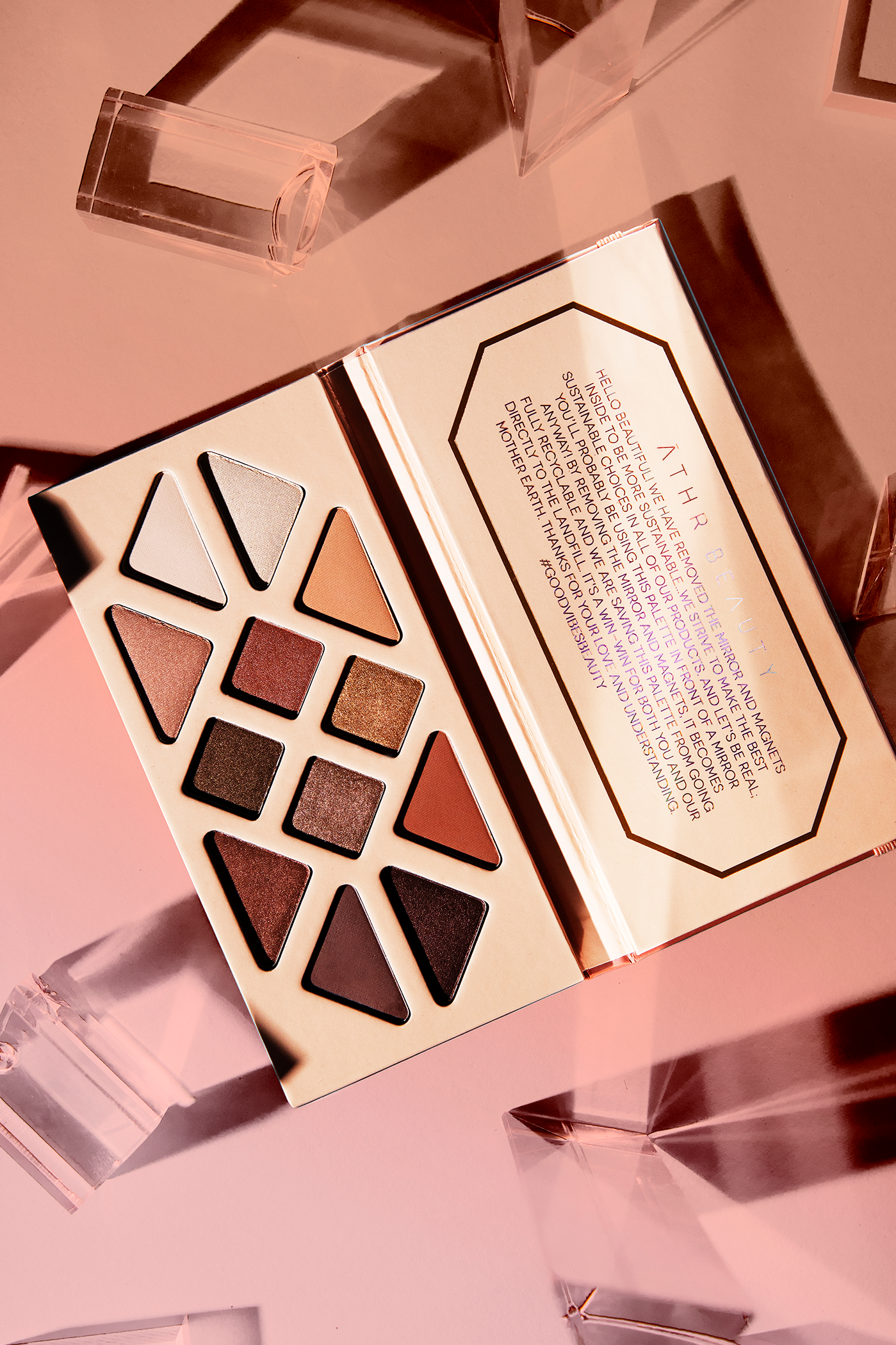 Editorial product image of the 12-Pan "Summer Solstice" Crystal Eyeshadow Palette, sitting open to show the shade color.