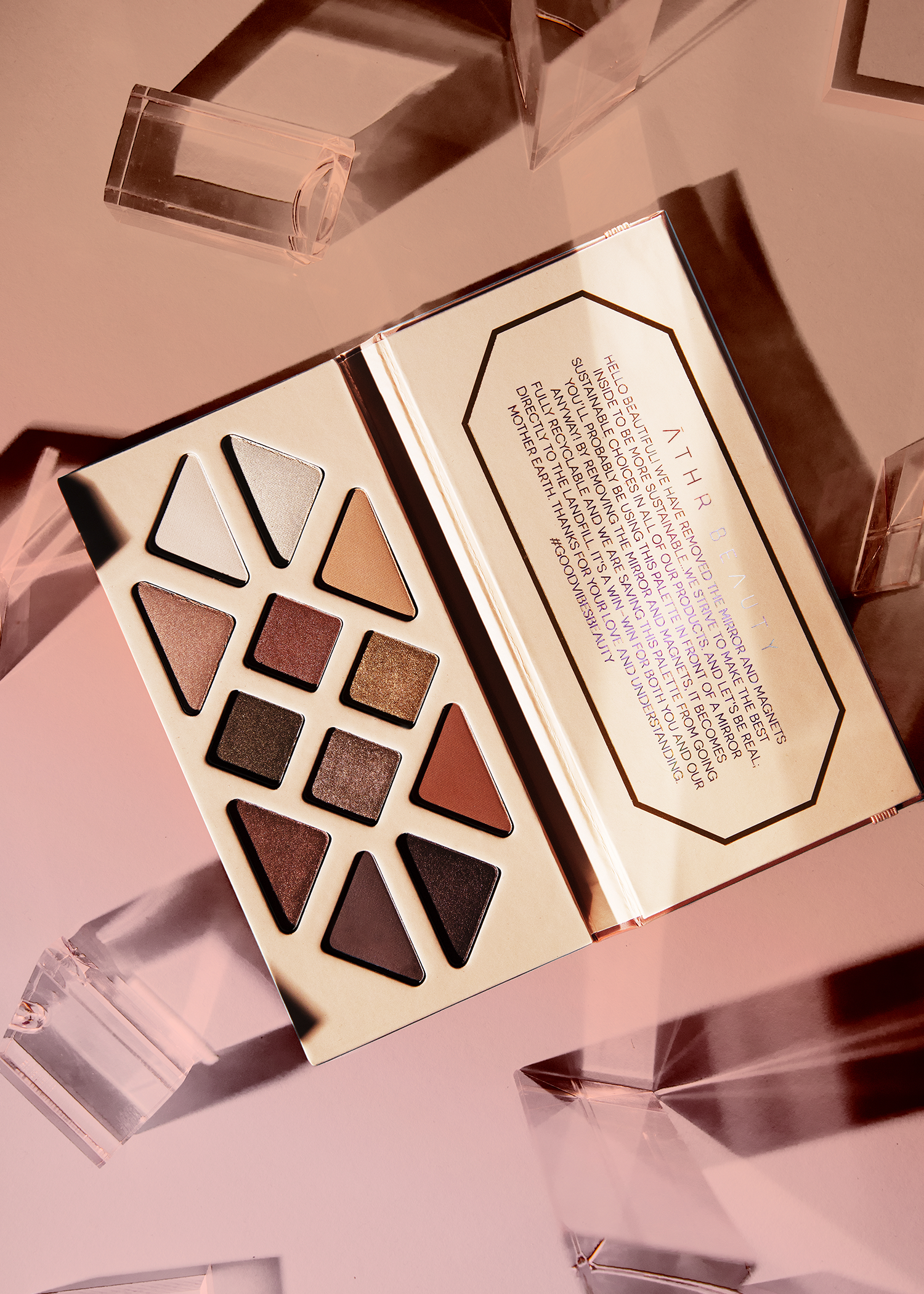 Editorial product image of the 12-Pan "Summer Solstice" Crystal Eyeshadow Palette, sitting open to show the shade color.