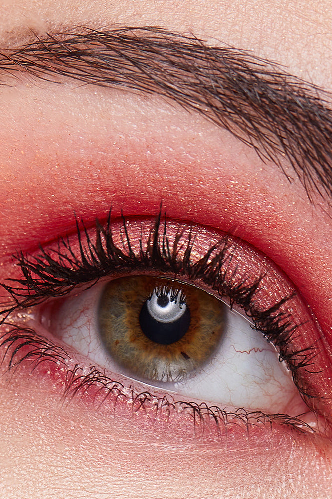 Closeup image of model wearing ATHR Beauty's Desert Sunset Crystal Eyeshadow Palette.