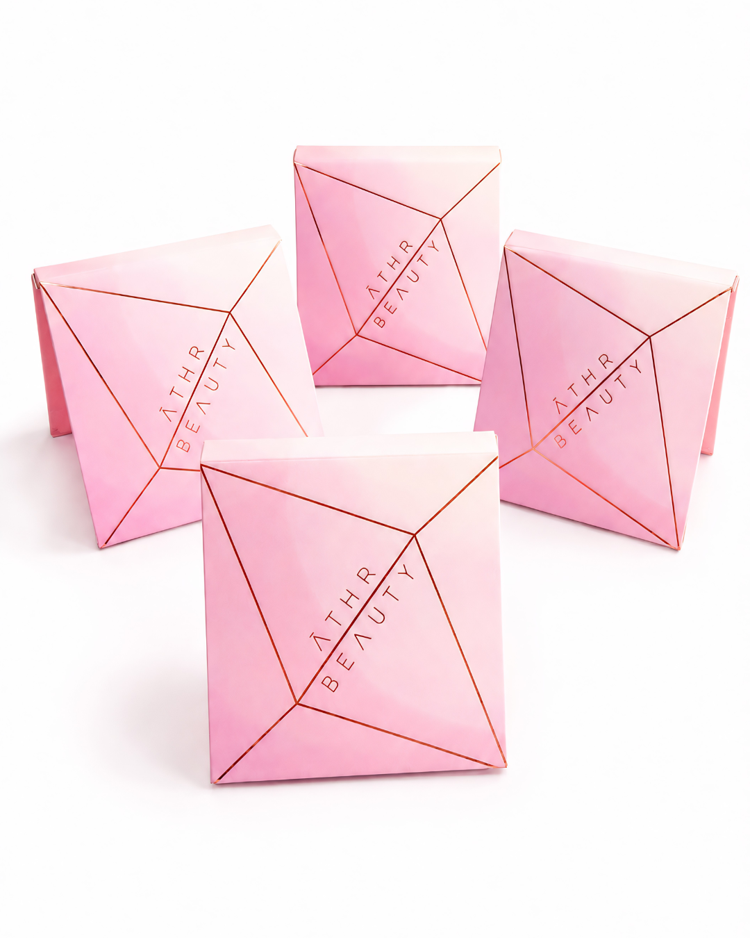 Four pink pyramid-shaped containers with 'Athr Beauty' branding on a white background