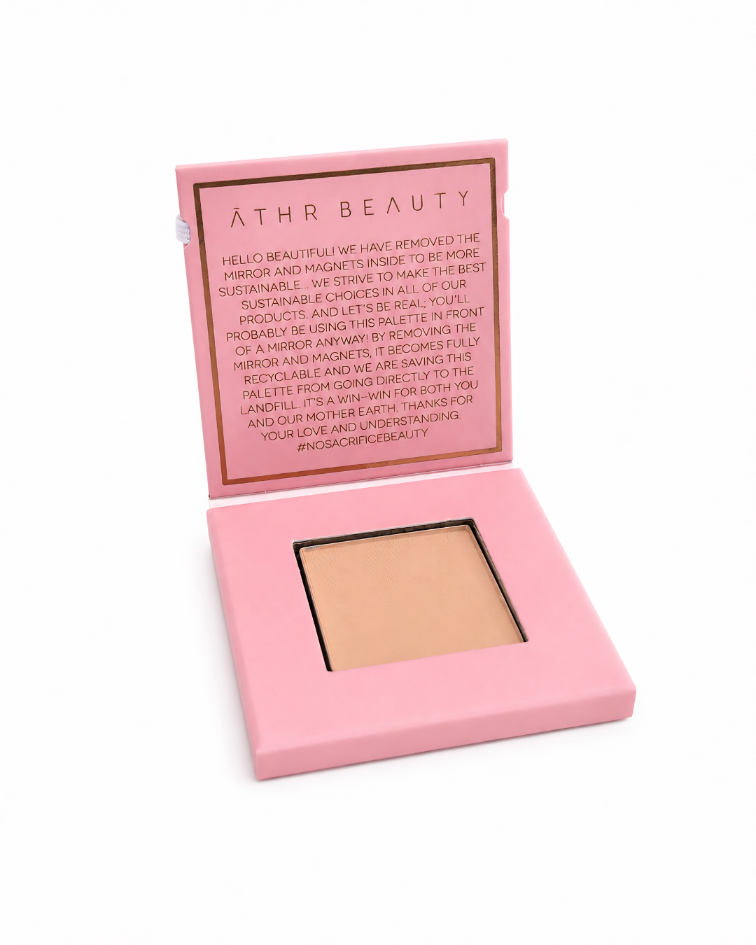Open 'Athr Beauty' compact of the Desert Mirage Blurring Powder in the shade 'Citrine Sand' (a soft, warm beige with a banana-yellow tint) in pink case on white background