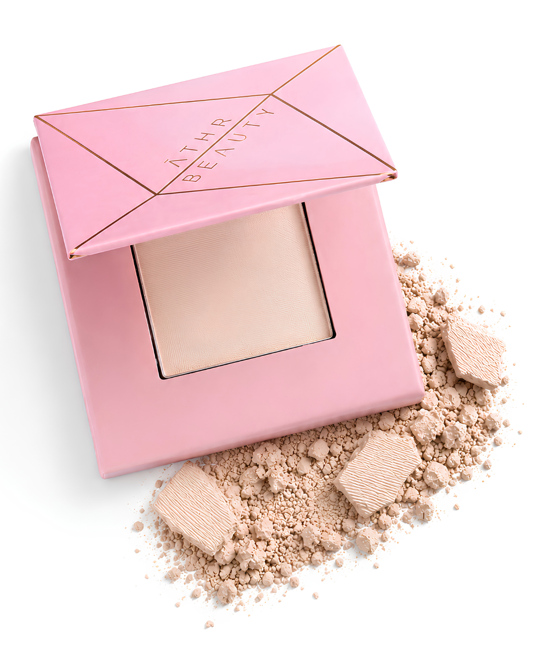 Athr Beauty's pink makeup compact of the 'Desert Mirage Blurring Powder' with open lid and scattered powder in the shade 'Rose Mesa' (a soft, creamy beige with a subtle pink tint) on a white background