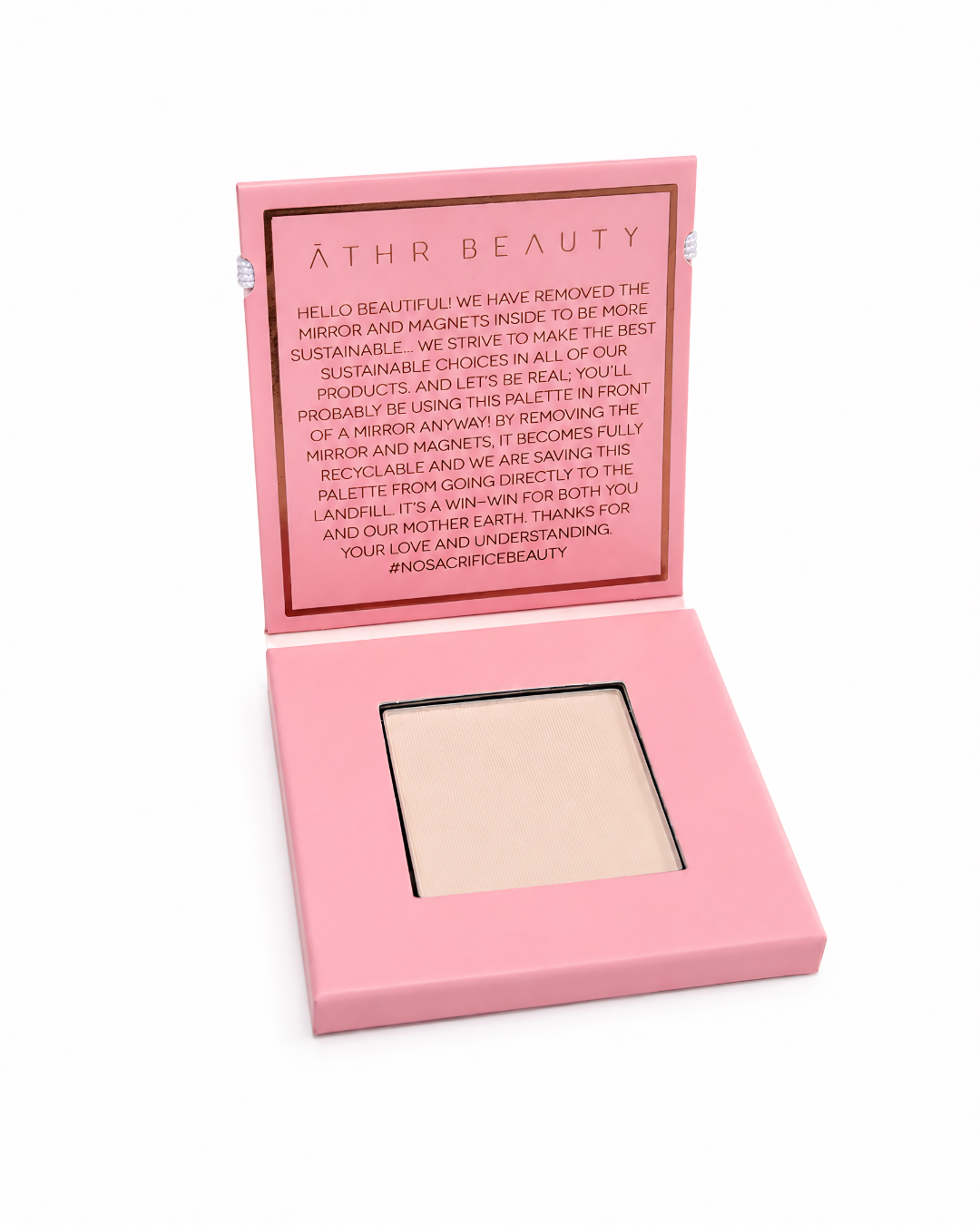 Athr Beauty pink makeup compact with an open lid showing the 'Desert Mirage Blurring Powder' in the shade 'Rose Mesa' (a soft, creamy beige with a subtle pink tint) on a white background