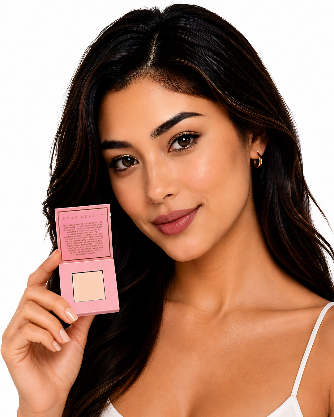 Model holding a pink powder compact of Athe Beauty's 'Desert Mirage Blurring Powder' with open lid in the shade 'Rose Mesa' (a soft, creamy beige with a subtle pink tint) with a white background