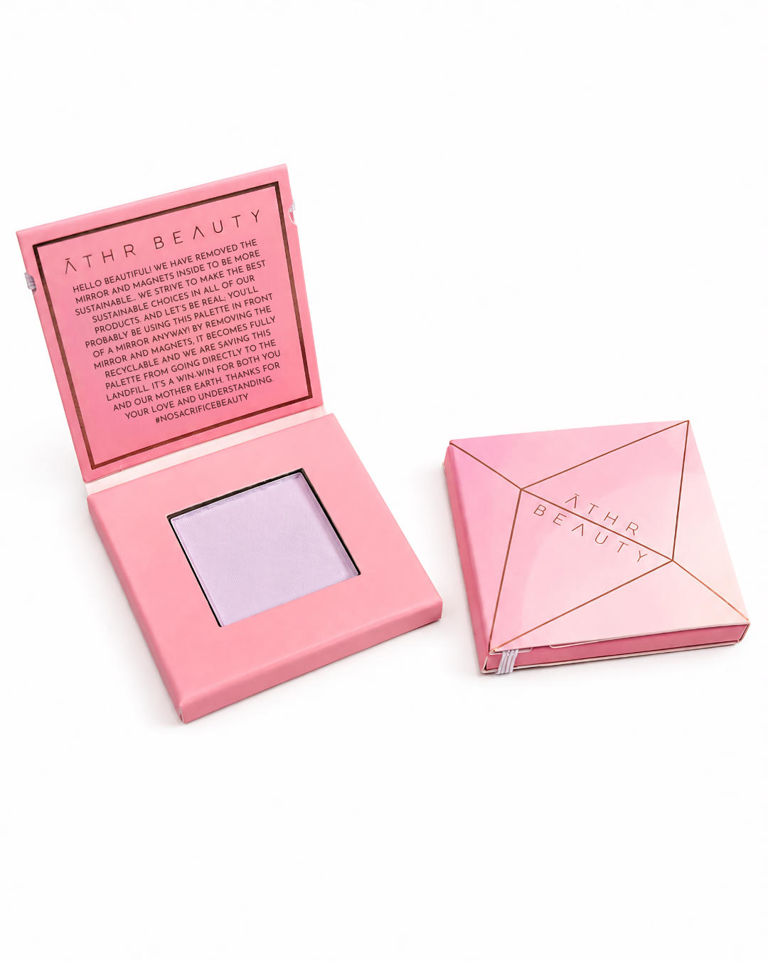 Pink 'Athr Beauty' makeup compact of the 'Desert Mirage Blurring Powder' in the shade 'Sagebrush' (a softly tinted lavender) on a white background