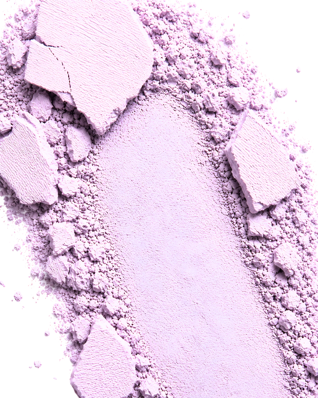 Close-up of lavender makeup powder with chunks on a white background