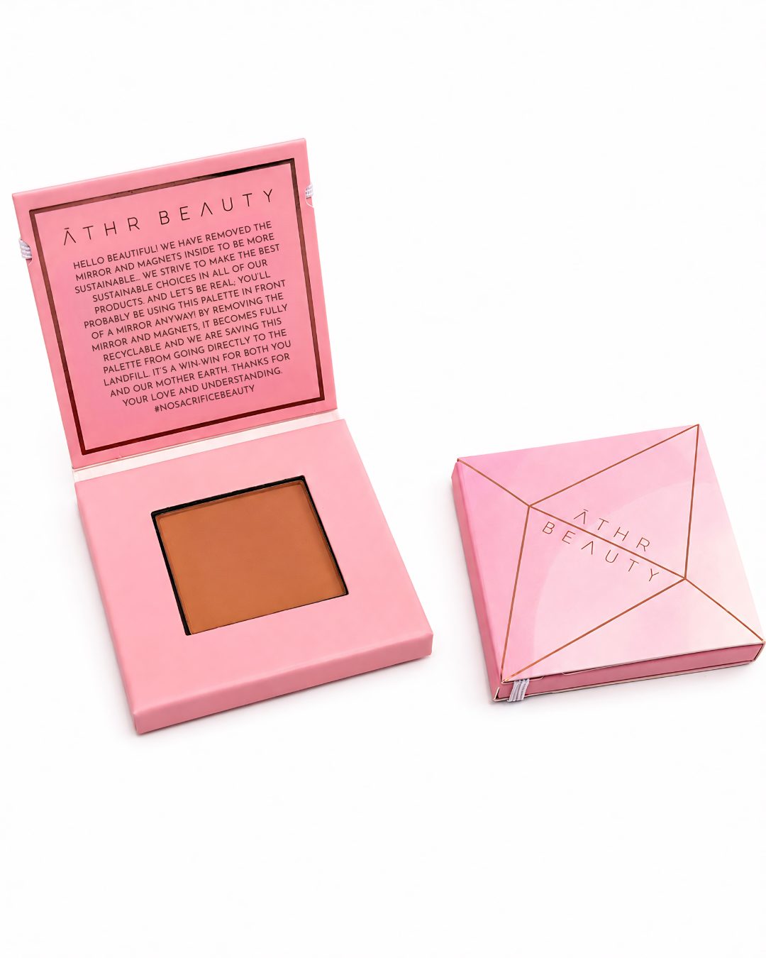 Pink makeup compact with brown powder and open lid showing brand text, on a white background.