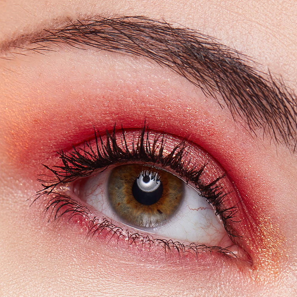 Closeup image of model wearing ATHR Beauty's Desert Sunset Crystal Eyeshadow Palette.